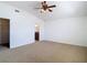 Spacious bedroom with ensuite bathroom access, carpet floors, and a modern ceiling fan at 19910 Wyndmill Cir, Odessa, FL 33556