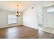 Bright dining area with wood-look flooring, a chandelier, and natural light at 19910 Wyndmill Cir, Odessa, FL 33556