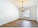 Bright dining area featuring wood-look flooring, natural light, and chandelier at 19910 Wyndmill Cir, Odessa, FL 33556