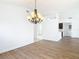 Dining area showcasing a chandelier, wood-look floors, and an open layout at 19910 Wyndmill Cir, Odessa, FL 33556