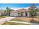 Charming single Gathering home with a two-car garage and well manicured lawn at 19910 Wyndmill Cir, Odessa, FL 33556