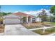 Street view of charming single Gathering home with a two-car garage at 19910 Wyndmill Cir, Odessa, FL 33556