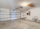Spacious garage with an automatic door opener, ample storage space, and concrete flooring at 19910 Wyndmill Cir, Odessa, FL 33556