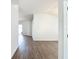 Hallway featuring wood-look flooring and white walls leading to the front door at 19910 Wyndmill Cir, Odessa, FL 33556