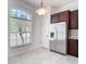 Bright kitchen nook area with stainless steel refrigerator and a window view at 19910 Wyndmill Cir, Odessa, FL 33556