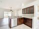 This kitchen features wood cabinets with glass doors, granite countertops, and stainless steel appliances at 19910 Wyndmill Cir, Odessa, FL 33556
