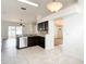 This kitchen features wood cabinets, stainless steel appliances, granite countertops, and white tile flooring at 19910 Wyndmill Cir, Odessa, FL 33556