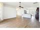 Bright, open-plan living room with wood-look flooring and a ceiling fan at 19910 Wyndmill Cir, Odessa, FL 33556