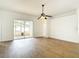 Living room featuring wood floors, ceiling fan, sliding glass door, and white walls at 19910 Wyndmill Cir, Odessa, FL 33556
