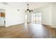 Open-plan living room with wood-look flooring, a ceiling fan, and sliding glass doors at 19910 Wyndmill Cir, Odessa, FL 33556