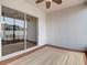 Covered patio with neutral rug, ceiling fan, and sliding glass doors overlooking the backyard at 19910 Wyndmill Cir, Odessa, FL 33556
