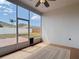 Enclosed sunroom with ceiling fan, neutral rug, and view of the brick patio and fenced backyard at 19910 Wyndmill Cir, Odessa, FL 33556