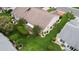 Aerial view of the home's spacious manicured lawn with mature trees and meticulously designed garden beds at 2015 W Del Webb Blvd, Sun City Center, FL 33573