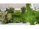 Aerial view of the home's backyard with a large manicured lawn and mature trees for added privacy at 2015 W Del Webb Blvd, Sun City Center, FL 33573