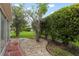 Landscaped backyard with well-maintained greenery, rocks, and plants, providing a peaceful outdoor space at 2015 W Del Webb Blvd, Sun City Center, FL 33573