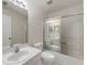 Bright bathroom featuring a sink, toilet, and shower with sliding glass doors at 2015 W Del Webb Blvd, Sun City Center, FL 33573