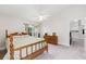 Sunlit bedroom with a bed, wood dresser, carpet flooring, and a ceiling fan at 2015 W Del Webb Blvd, Sun City Center, FL 33573