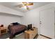 Cozy bedroom with a ceiling fan, bed, tv, and a white door at 2015 W Del Webb Blvd, Sun City Center, FL 33573