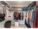 Organized closet with shelves, hanging clothes, and a dehumidifier on the floor at 2015 W Del Webb Blvd, Sun City Center, FL 33573