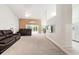 Bright and airy living room with neutral carpet, a ceiling fan, and sliding glass doors leading to the backyard at 2015 W Del Webb Blvd, Sun City Center, FL 33573