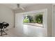 Bright living room with white tile floors and a sliding glass door to the outside, letting in natural light at 2015 W Del Webb Blvd, Sun City Center, FL 33573