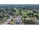 Aerial view of a residential neighborhood beside a golf course with mature trees at 2219 Summit View Dr, Valrico, FL 33596