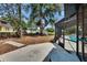 Expansive backyard with a screened pool, mature trees, and concrete patio area at 2219 Summit View Dr, Valrico, FL 33596