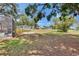Expansive backyard featuring a fire pit, mature trees, and lush lawn with views of a golf course at 2219 Summit View Dr, Valrico, FL 33596