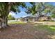 View of the backyard with a screened pool area and a well maintained lawn at 2219 Summit View Dr, Valrico, FL 33596