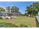 Large backyard with a screened-in pool enclosure and a small car in the foreground at 2219 Summit View Dr, Valrico, FL 33596