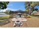 A large backyard features a fire pit and a covered screened pool at 2219 Summit View Dr, Valrico, FL 33596