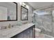 Bathroom with gray shower tile, gold hardware, and a double sink vanity at 2219 Summit View Dr, Valrico, FL 33596