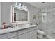 The bathroom features a well lit mirror, modern vanity, and a glass enclosed shower with marble tiling at 2219 Summit View Dr, Valrico, FL 33596