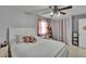 Cozy bedroom featuring a ceiling fan, neutral walls, and comfortable furnishings at 2219 Summit View Dr, Valrico, FL 33596