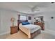 A cozy bedroom featuring neutral walls, wooden furniture, and a ceiling fan at 2219 Summit View Dr, Valrico, FL 33596