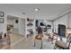 Versatile bonus room with tile floors, media setup, bar area, and view to the kitchen at 2219 Summit View Dr, Valrico, FL 33596