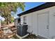 The home's exterior featuring an AC unit, siding, an outdoor area, and a small storage shed at 2219 Summit View Dr, Valrico, FL 33596