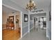 Elegant foyer with light blue wall color, shiny tile floors, chandelier, and a view of the formal living room at 2219 Summit View Dr, Valrico, FL 33596