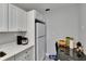 Eat-in kitchen features white cabinets, white refrigerator, and adjacent dining space at 2219 Summit View Dr, Valrico, FL 33596