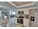 Kitchen featuring stainless appliances, bar seating and views to the living area at 2219 Summit View Dr, Valrico, FL 33596