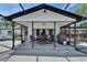 Covered outdoor patio with dining and pool views, ideal for backyard relaxation at 2219 Summit View Dr, Valrico, FL 33596