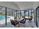 Outdoor dining set on a screened patio with a view of the backyard pool at 2219 Summit View Dr, Valrico, FL 33596