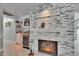 Living room featuring a fireplace, bar area, tile flooring and modern finishes at 2219 Summit View Dr, Valrico, FL 33596