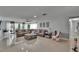 Spacious living room with tile floors, a large sectional sofa, a ceiling fan, and access to the screened lanai at 2219 Summit View Dr, Valrico, FL 33596