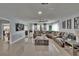 Spacious living room with tile floors, a large sectional sofa, a ceiling fan, and access to the screened lanai at 2219 Summit View Dr, Valrico, FL 33596