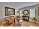 Elegant living room featuring hardwood floors, classic furniture, decorative wall art, and natural light from large windows at 2219 Summit View Dr, Valrico, FL 33596