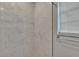 Close-up view of a tile shower and bathroom window, featuring a chrome towel bar at 2219 Summit View Dr, Valrico, FL 33596