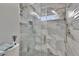The shower has gray textured tile, glass door, and dual shower heads at 2219 Summit View Dr, Valrico, FL 33596
