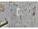 Close up on the new shower with glass doors, marble tile, and a rainfall shower head at 2219 Summit View Dr, Valrico, FL 33596