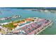 Beautiful aerial view of the community including tennis courts, baseball fields, pool and boat docks, with ocean views at 230 Medallion Blvd # G, Madeira Beach, FL 33708
